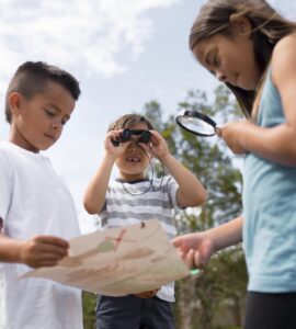 tra bambini che giocano alla caccia al tesoro con una mappa in mano